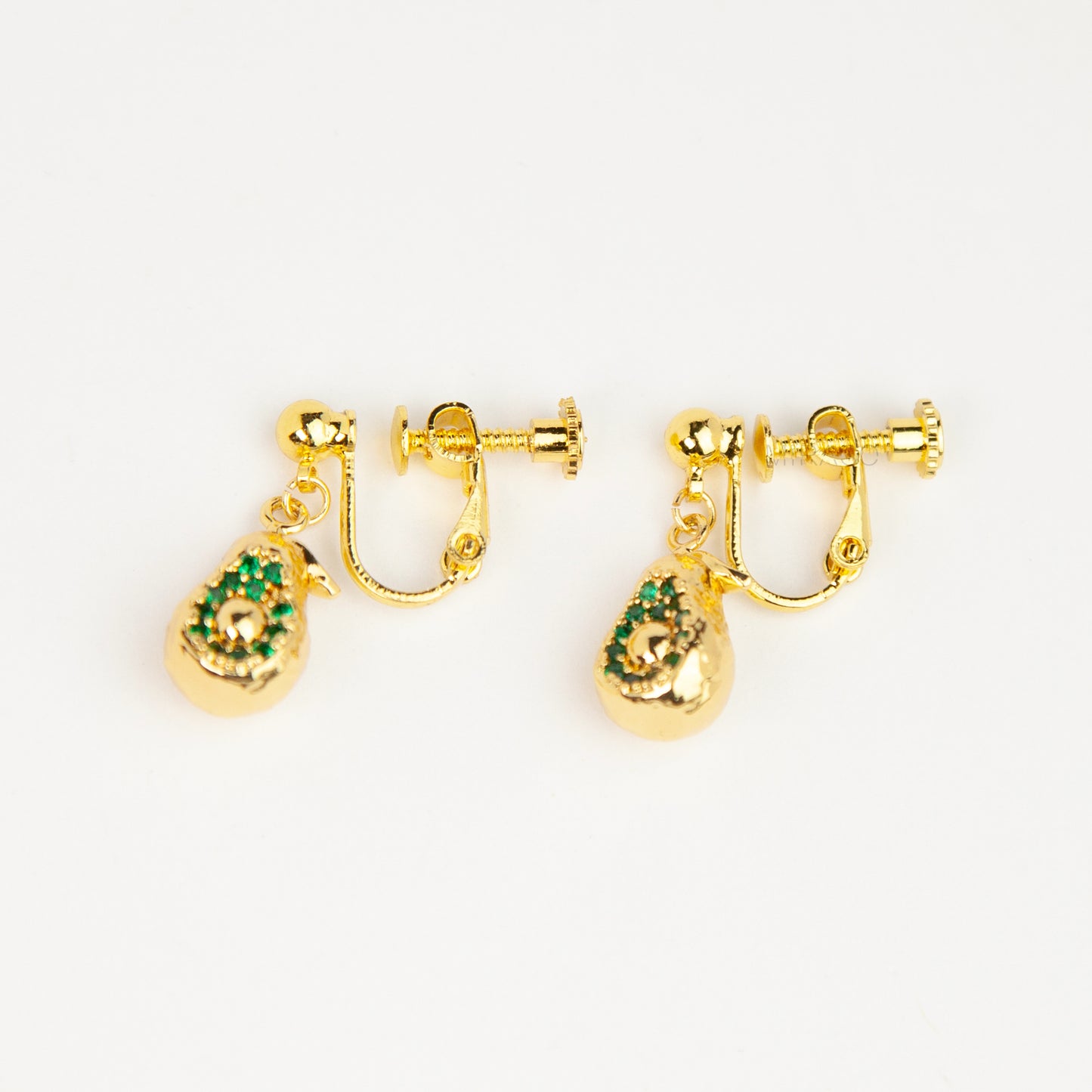 Pair of gold-toned non-pierced avocado clip-on drop earrings with green crystal accents and adjustable screw-back mechanisms.