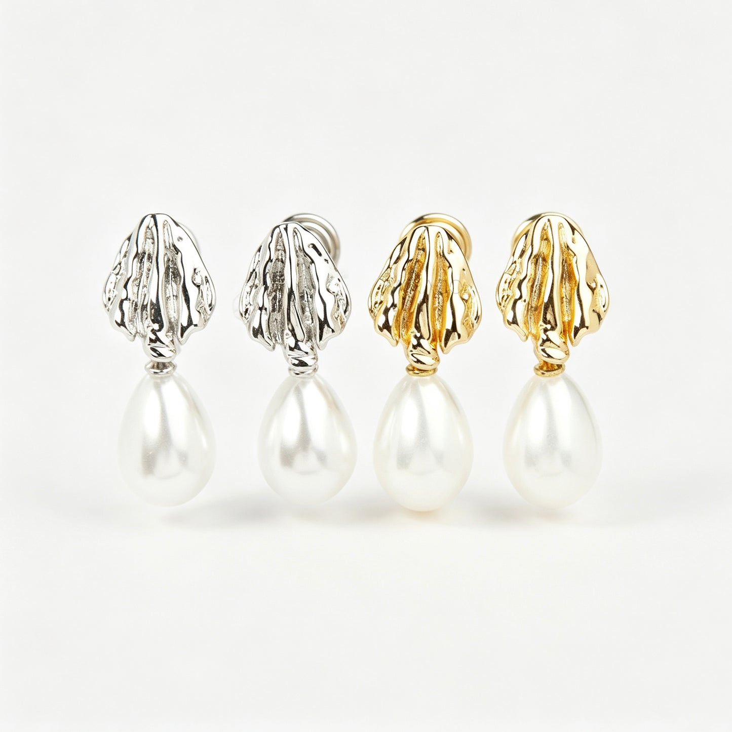 Pair of gold and silver textured shell clip-on earrings featuring white teardrop faux pearls with pain-free coil backs for non-pierced ears displayed against a clean white background.