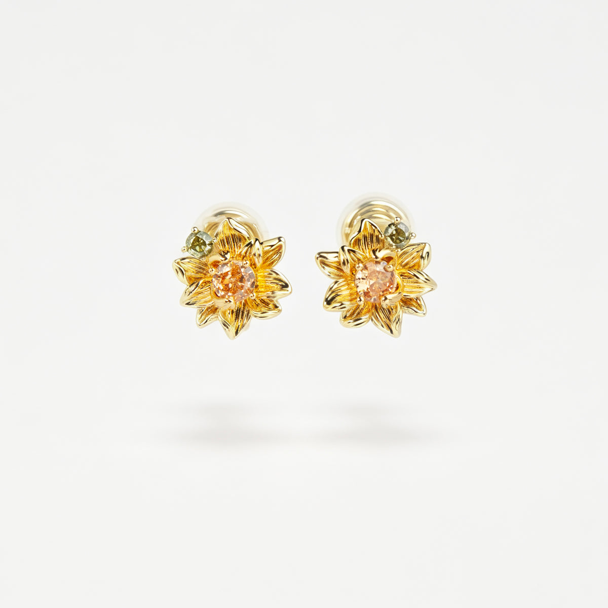 Pair of detailed gold sunflower clip-on stud earrings with amber crystal centers and olive green stone accents