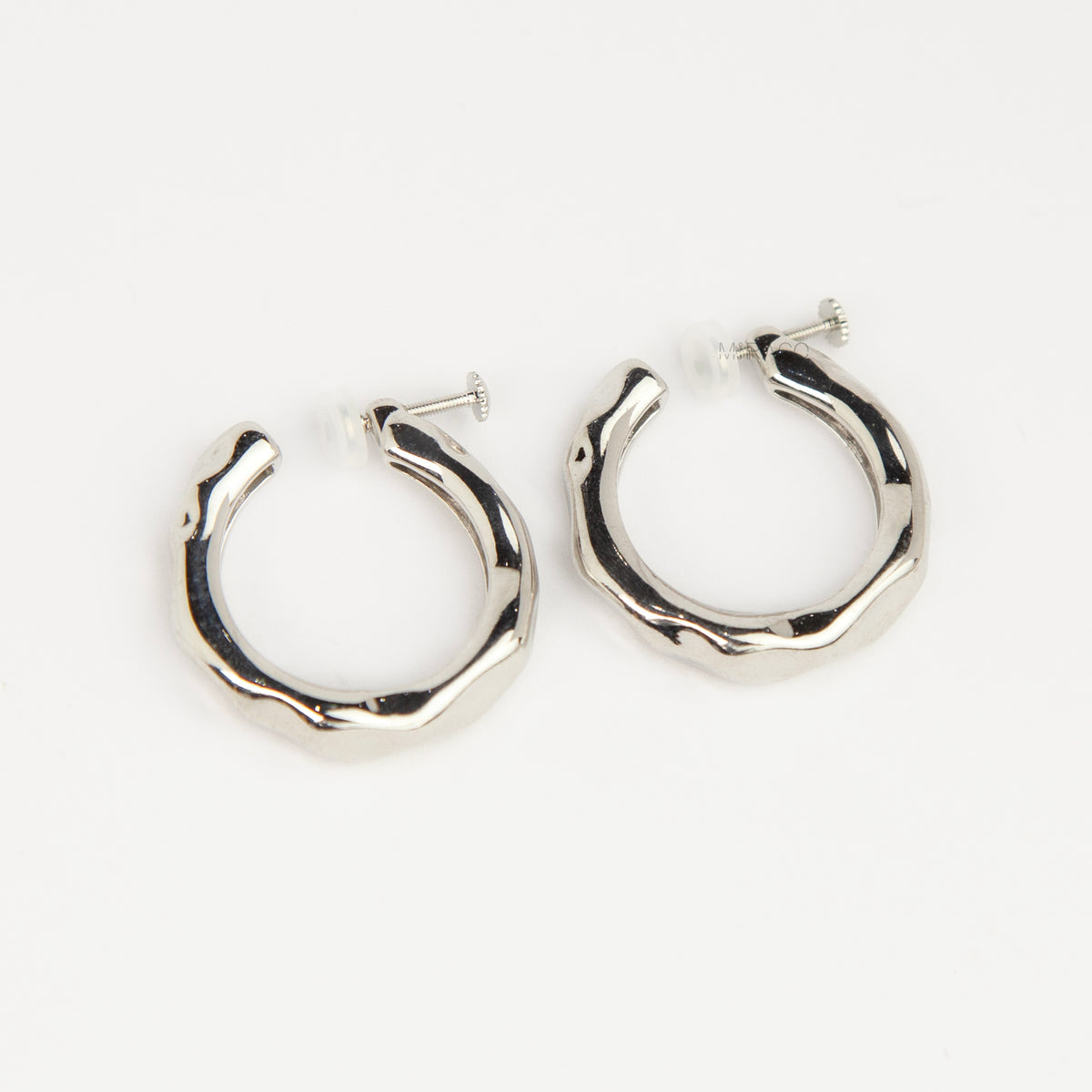 Silver chunky molten clip-on hoop earrings with adjustable screw-back closures featuring an organic wavy textured finish