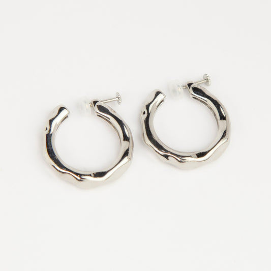 Silver chunky molten clip-on hoop earrings with adjustable screw-back closures featuring an organic wavy textured finish