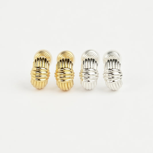 Gold and silver textured ribbed coil-back clip-on stud earrings displayed side by side