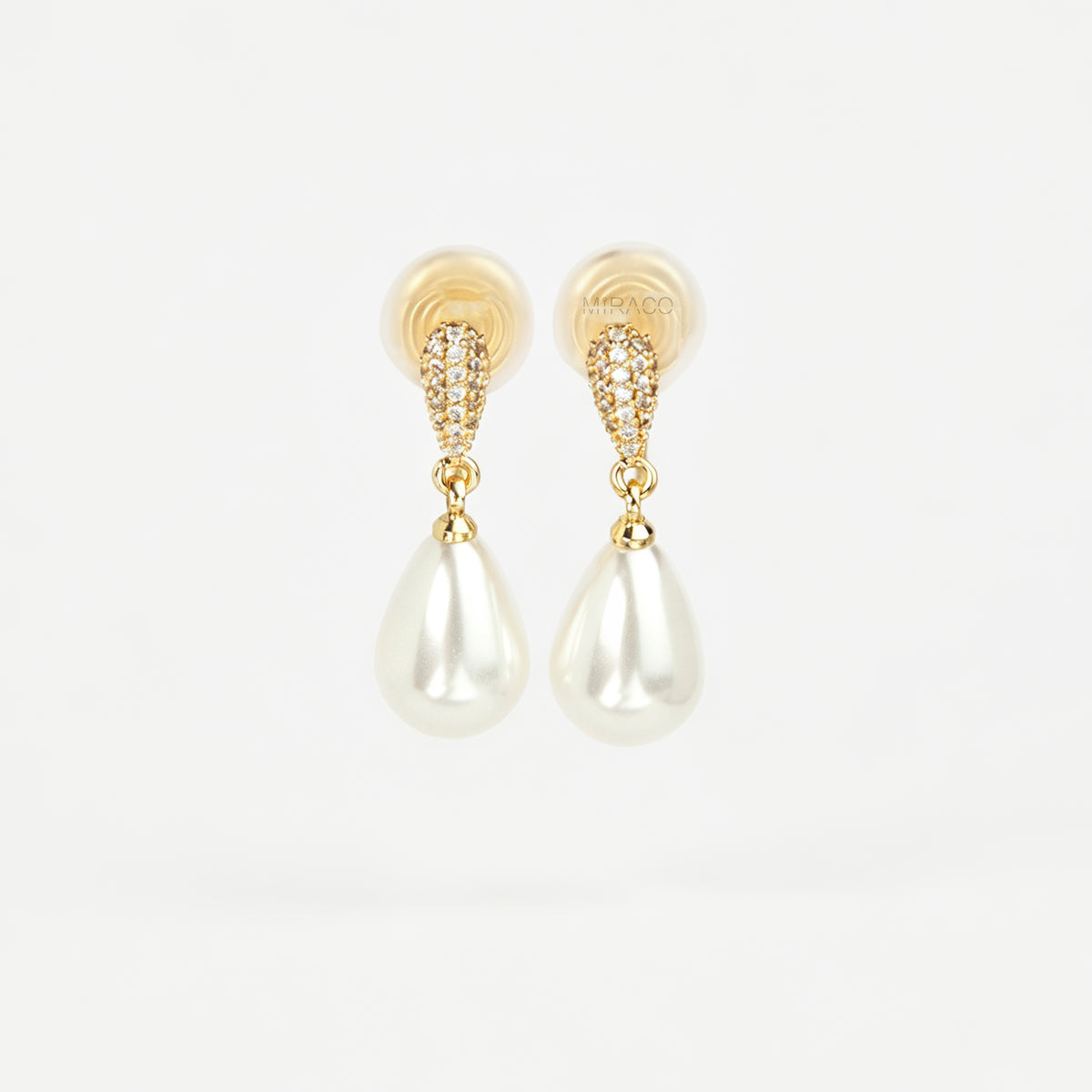 Gold coil-back clip-on drop earrings featuring a pave crystal teardrop stud and dangling white pear-shaped pearl 