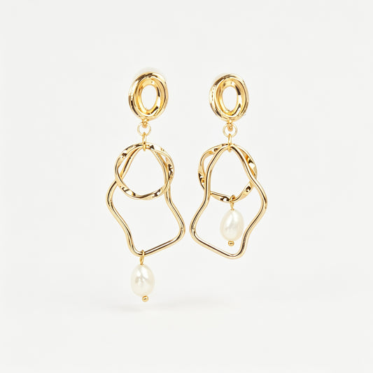 Gold coil-back clip-on statement earrings featuring abstract wavy geometric hoops and dangling teardrop pearl accents.