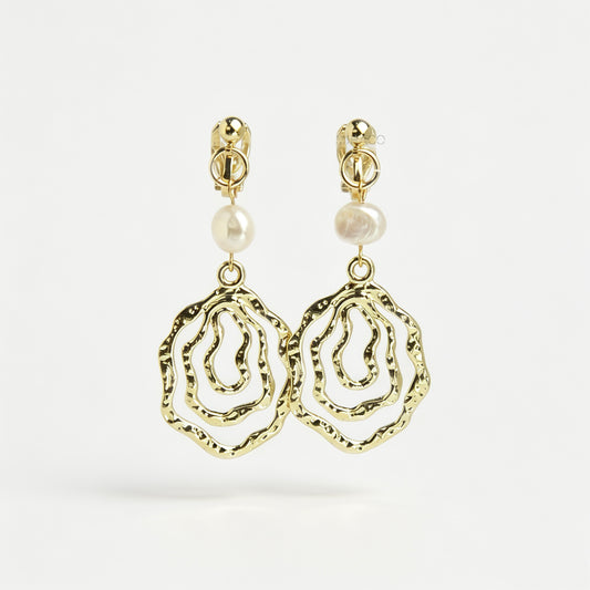 Gold mini-clip clip-on drop earrings featuring a natural freshwater pearl above a concentric hammered wavy openwork pendant