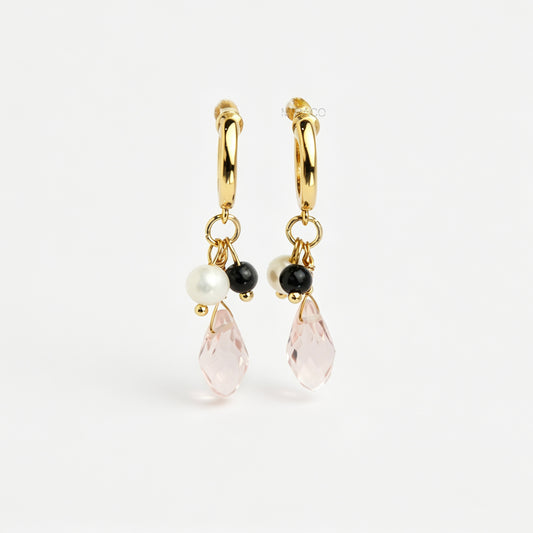Gold screw-back clip-on hoop earrings featuring a faceted pink teardrop crystal charm, small white pearl, and black bead
