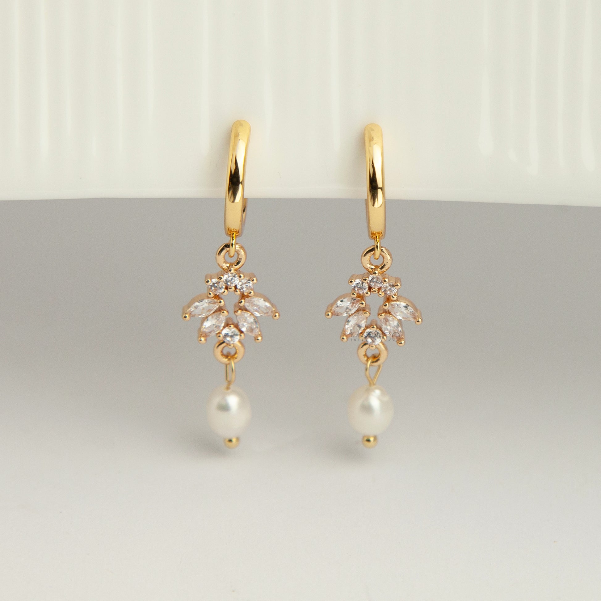Gold screw-back clip-on hoop earrings with a sparkling cubic zirconia marquise sunburst charm and hanging white pearl drop