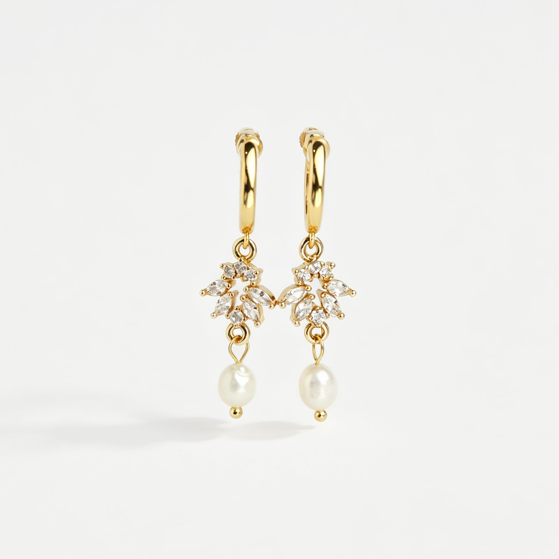 Gold screw-back clip-on hoop earrings with a sparkling cubic zirconia marquise sunburst charm and hanging white pearl drop