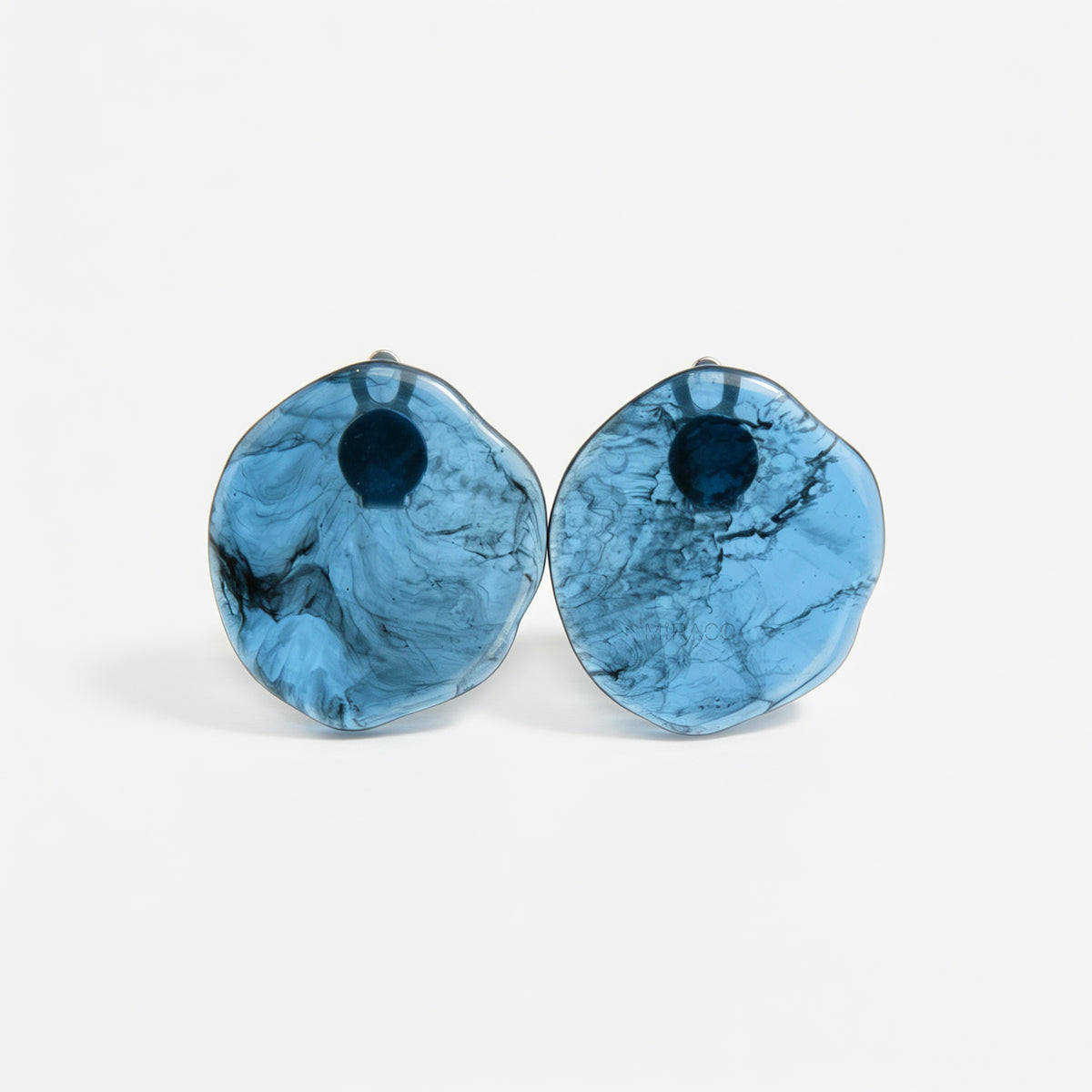 Large organic oval clip-on earring featuring a blue and black marbled resin design
