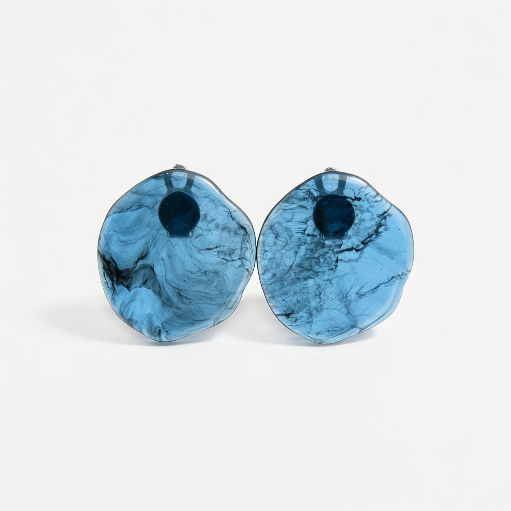 Large organic oval clip-on earring featuring a blue and black marbled resin design