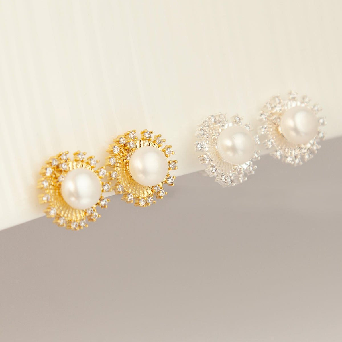 Gold and silver clip-on stud earrings featuring a central freshwater pearl framed by a pavé cubic zirconia sunburst halo with round cushioned coil backs.