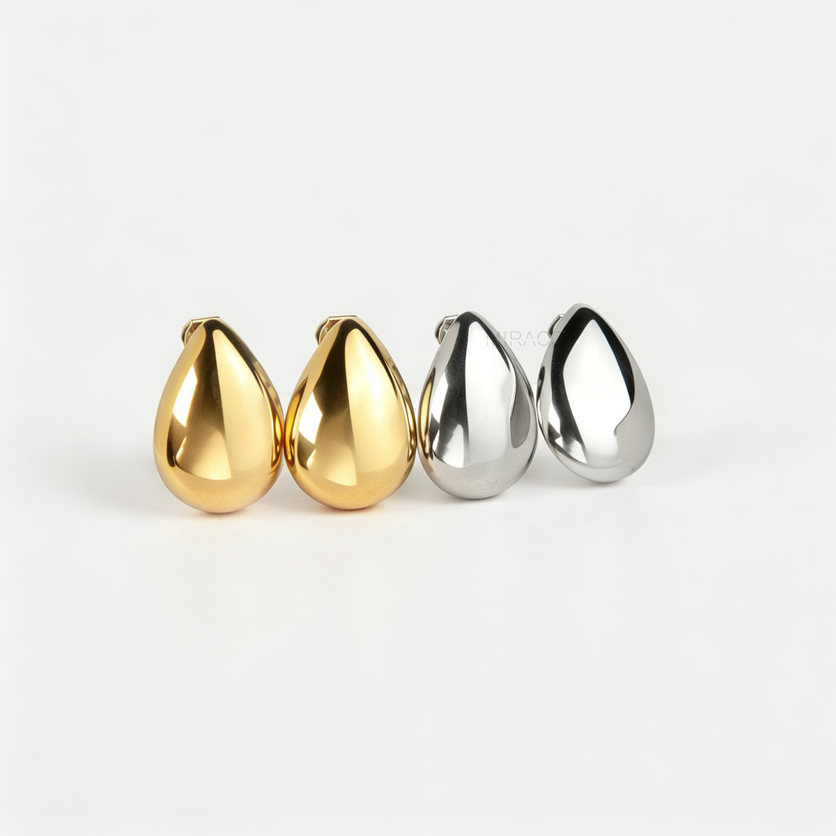 Polished gold and silver teardrop waterdrop clip-on earrings with mini-clip backings displayed side-by-side on a plain white background.