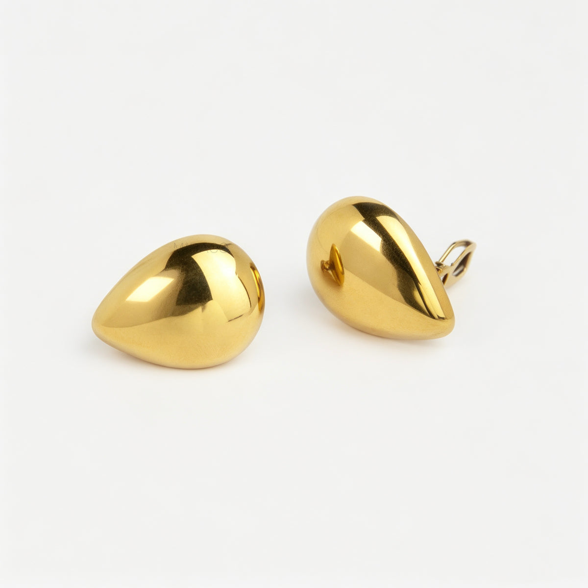 Polished gold and silver teardrop waterdrop clip-on earrings with mini-clip backings displayed side-by-side on a plain white background.