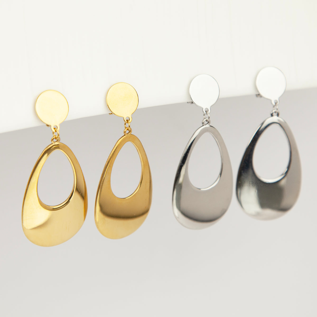 bold gold-plated stainless steel hollow teardrop clip-on dangle earrings with discreet mini-clip backs for non-pierced ears.