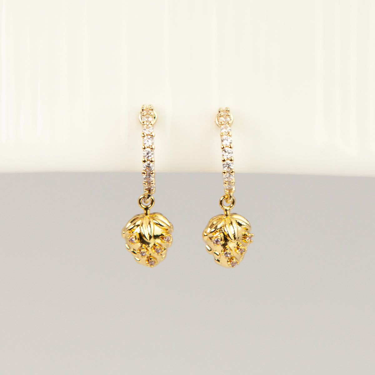 gold-plated strawberry clip-on hoop earrings with pavé cubic zirconia and a comfortable coil back for non-pierced ears.