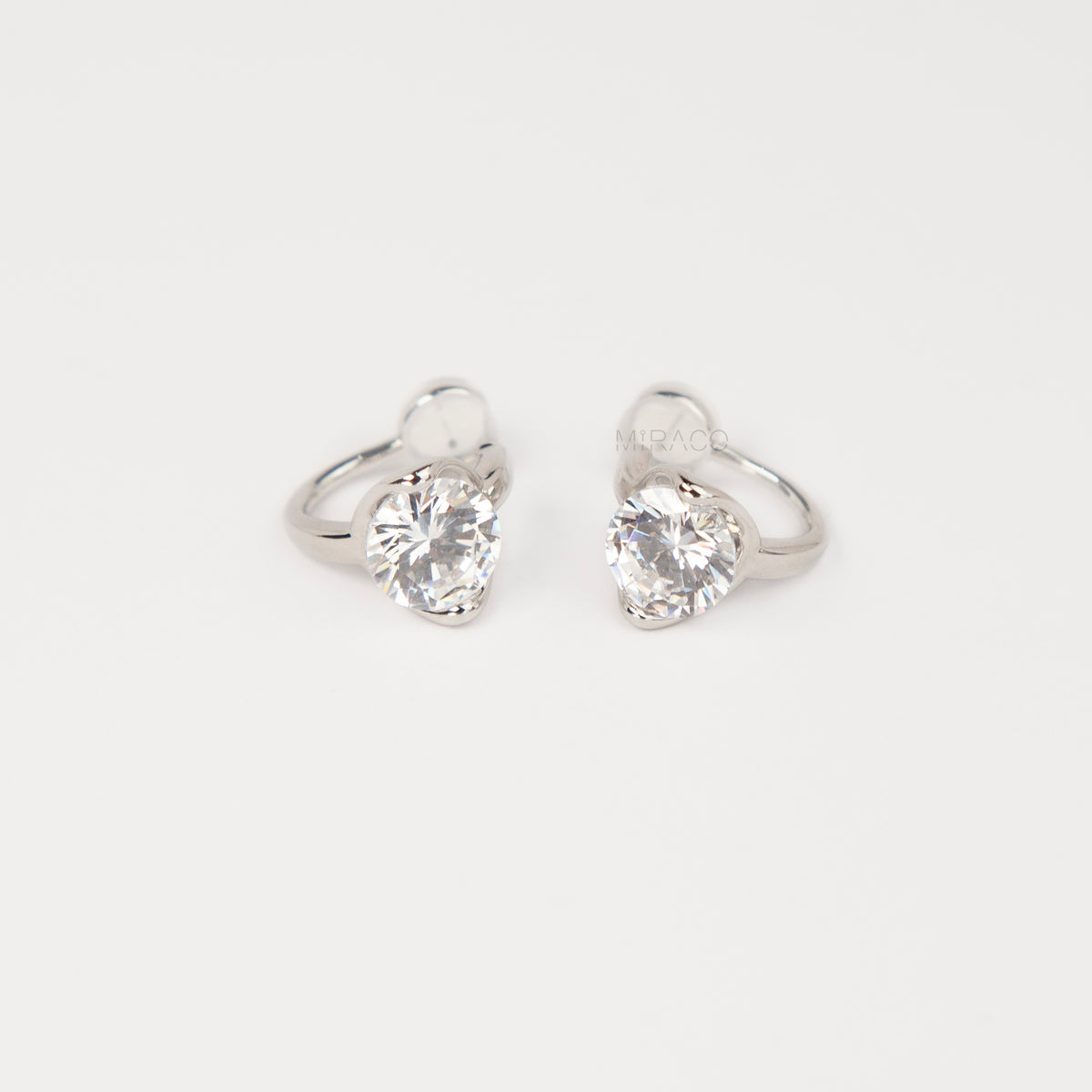 Silver solitaire cubic zirconia clip-on earrings with soft round silicon backings for non-pierced ears.