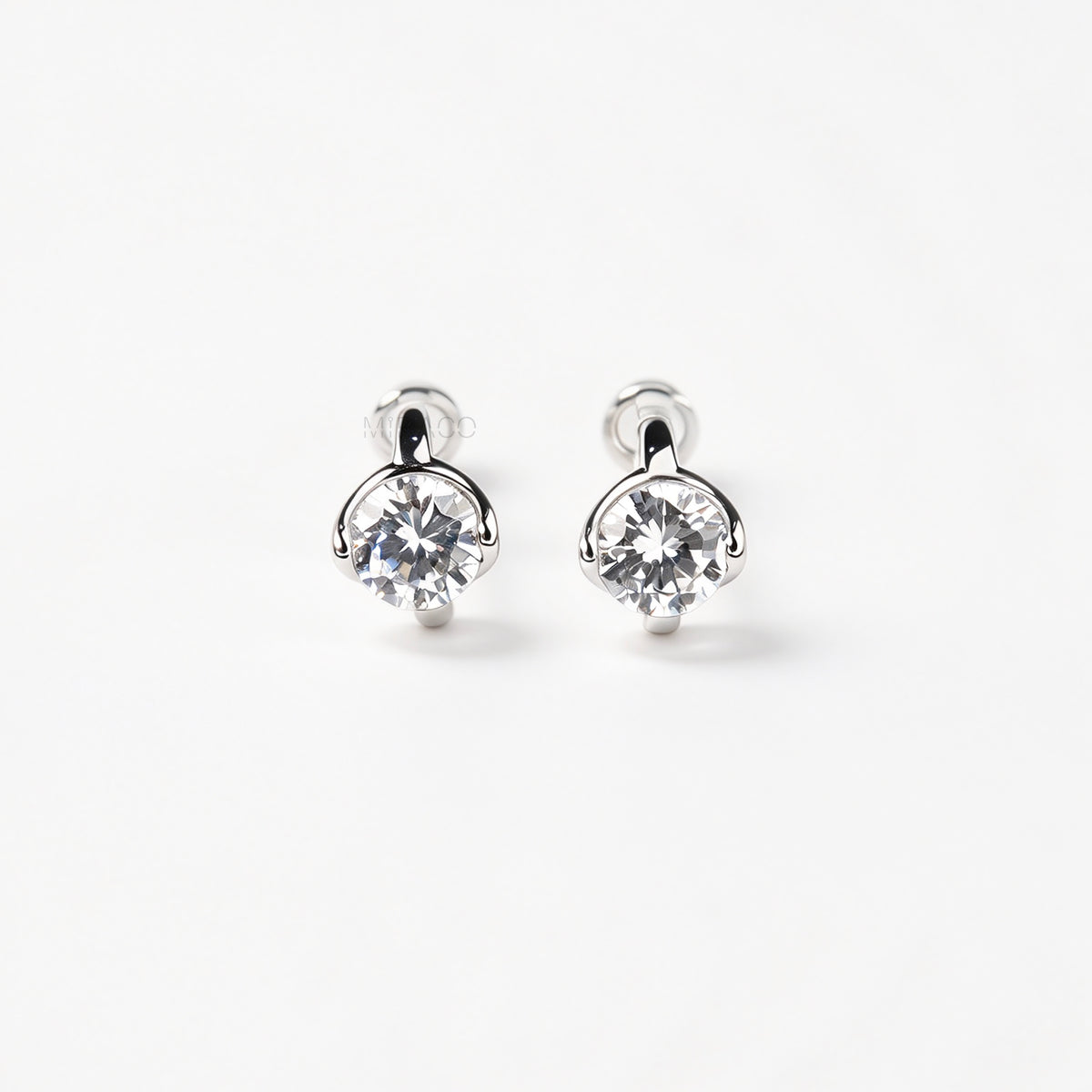 Silver solitaire cubic zirconia clip-on earrings with soft round silicon backings for non-pierced ears.