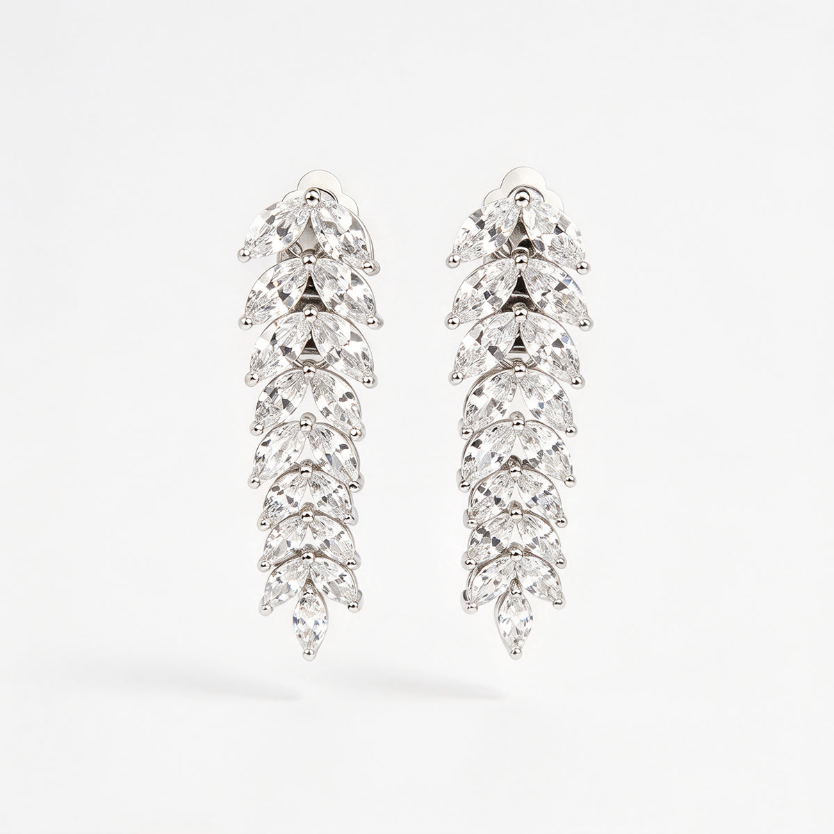 Pair of silver marquise cubic zirconia leaf drop clip-on earrings with paddle backs.