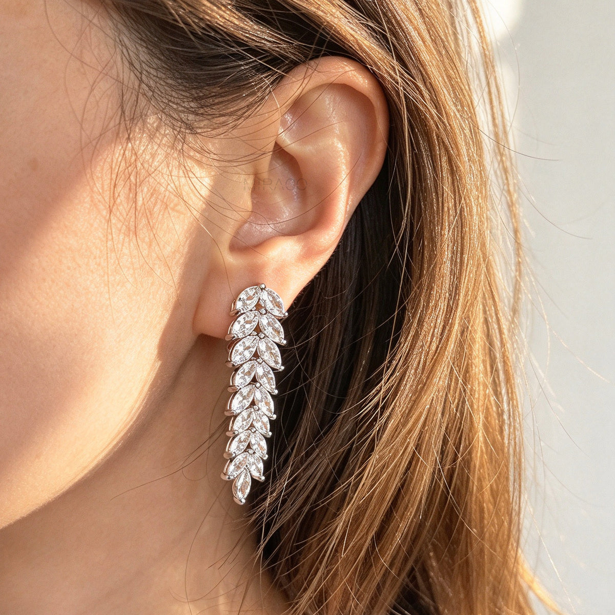Pair of silver marquise cubic zirconia leaf drop clip-on earrings with paddle backs.