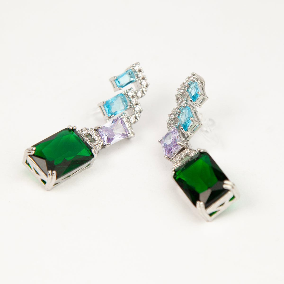 Art deco style multicolor clip-on drop earrings with blue, purple, and green emerald-cut crystals and invisible clear backs.