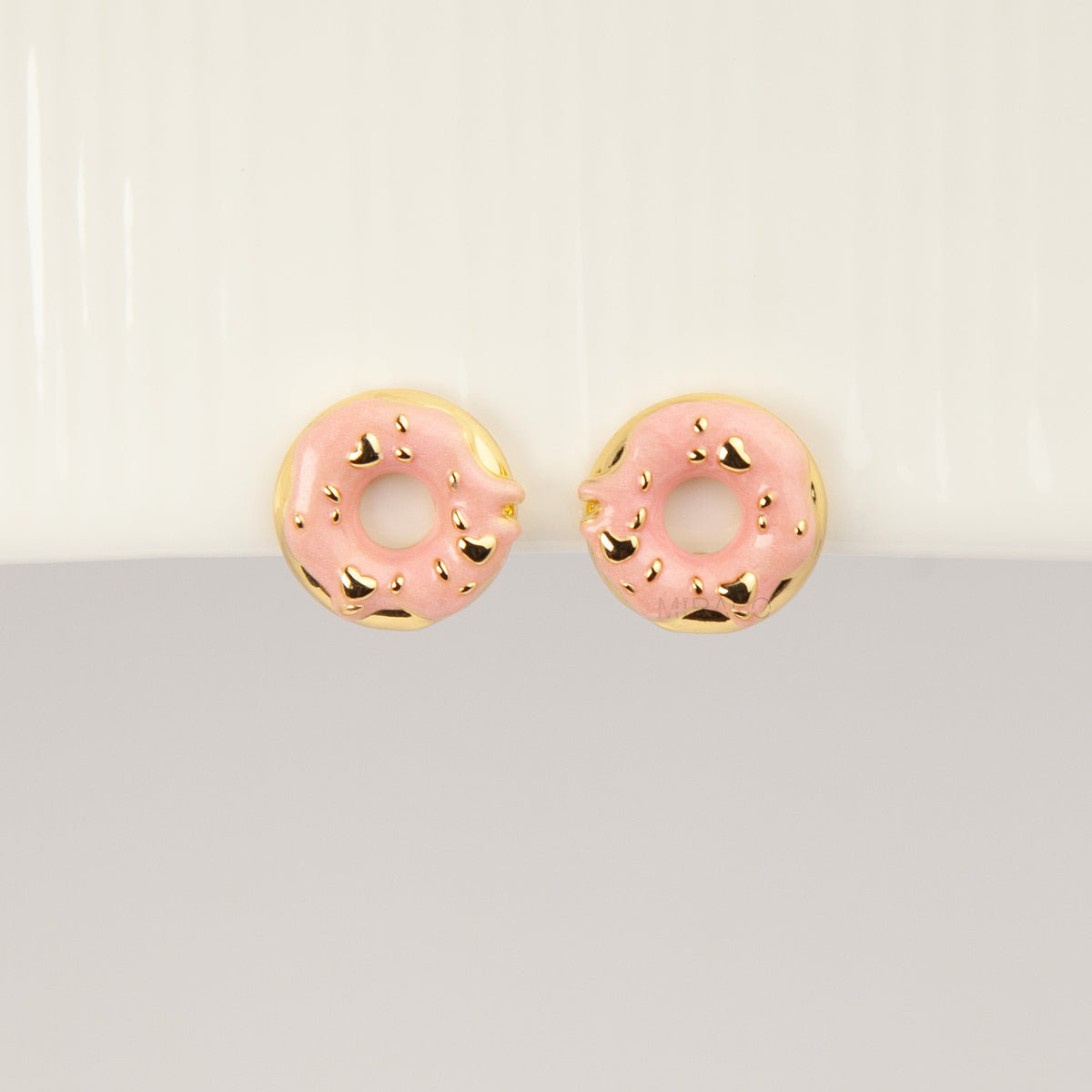 pink enamel donut clip-on earrings with gold sprinkles and coil back non-pierced closure