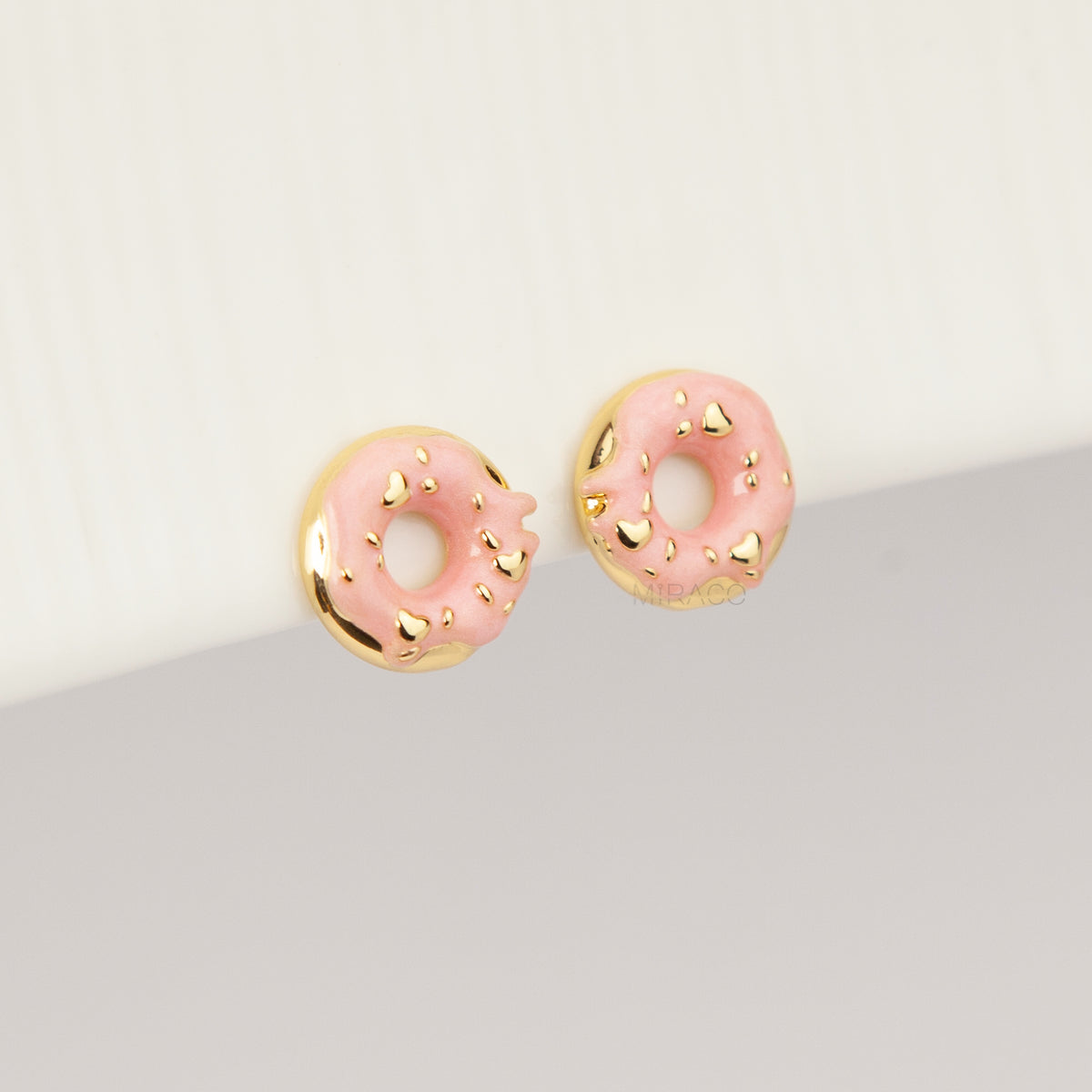 pink enamel donut clip-on earrings with gold sprinkles and coil back non-pierced closure