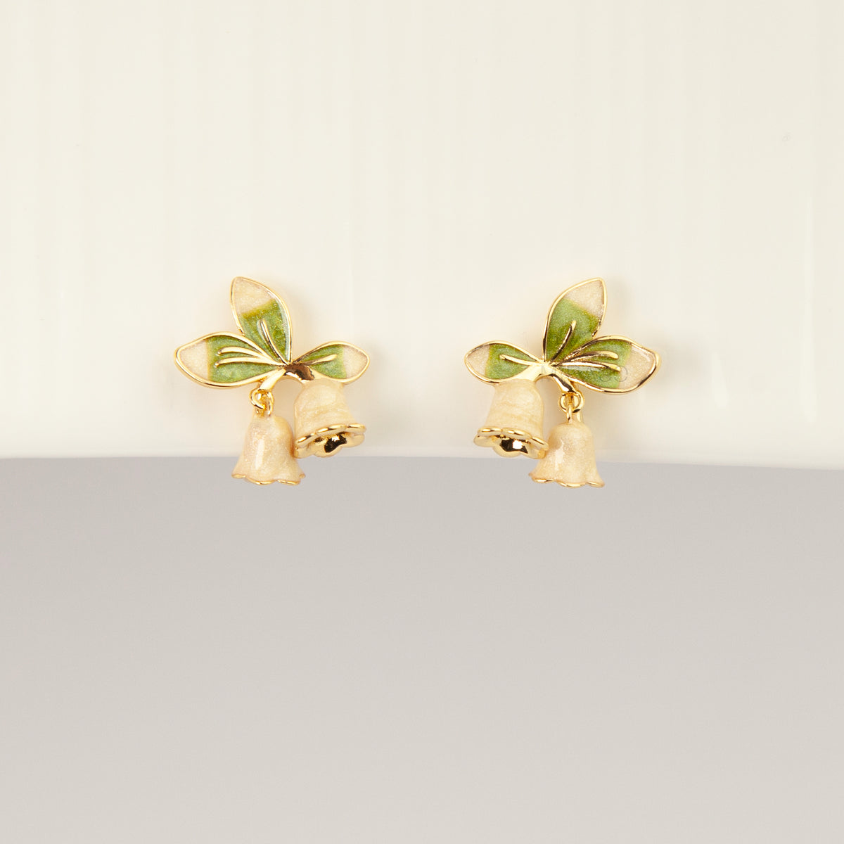 Lily of the Valley floral coil back clip-on earrings with green enamel leaves and pearlescent white flower drops