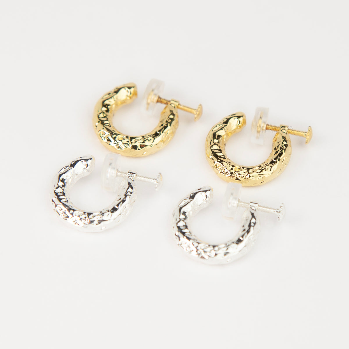 Gold and silver textured molten chunky hoop clip-on earrings with adjustable screw back closures and silicone comfort pads.