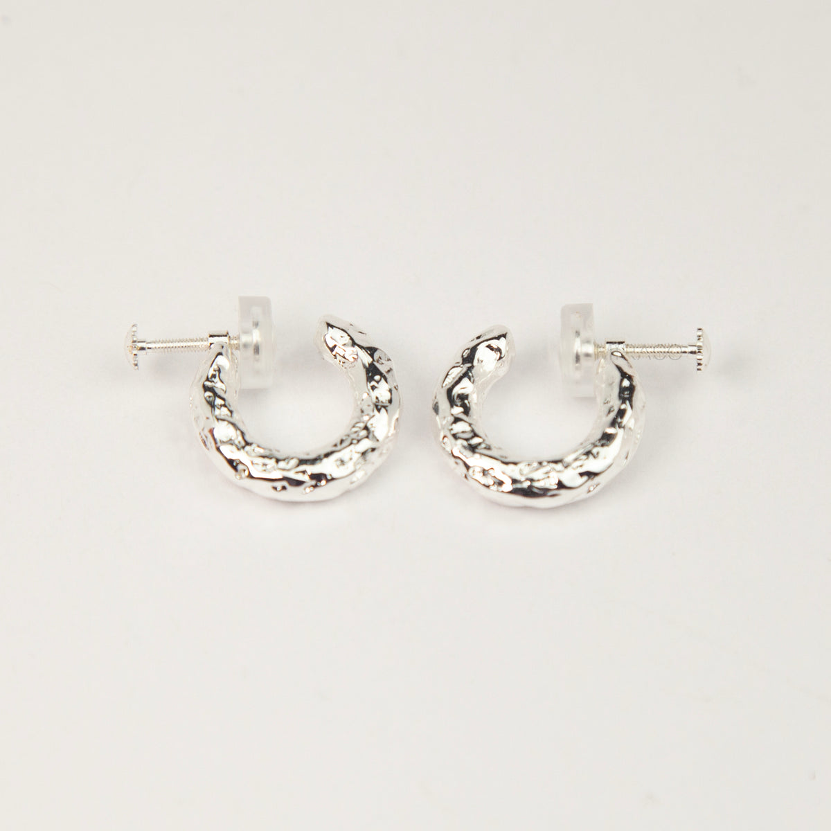 silver textured molten chunky hoop clip-on earrings with adjustable screw back closures and silicone comfort pads.