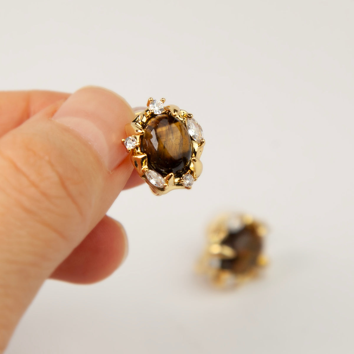 vintage oval tiger's eye cabochon clip-on earrings with cubic zirconia halo accents and coil back non-pierced closure