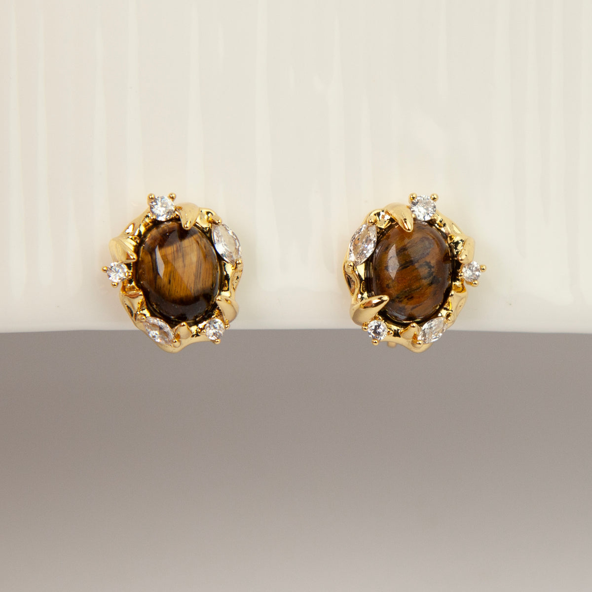 vintage oval tiger's eye cabochon clip-on earrings with cubic zirconia halo accents and coil back non-pierced closure