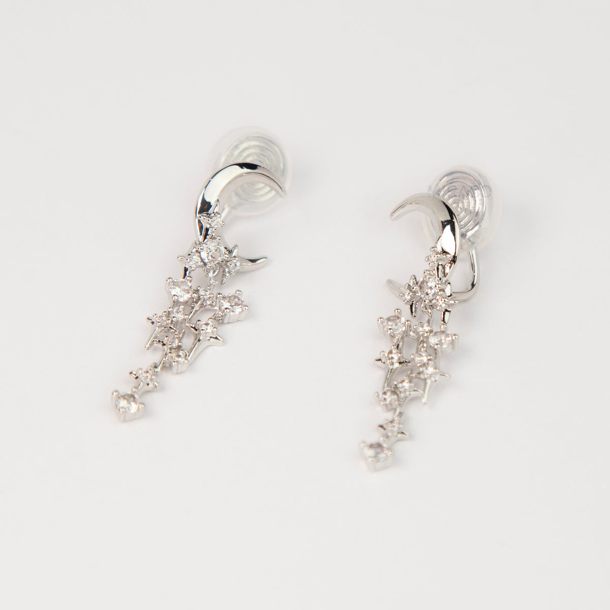 silver celestial crescent moon and starburst dangle clip-on earrings set with cubic zirconia and coil back non-pierced closure