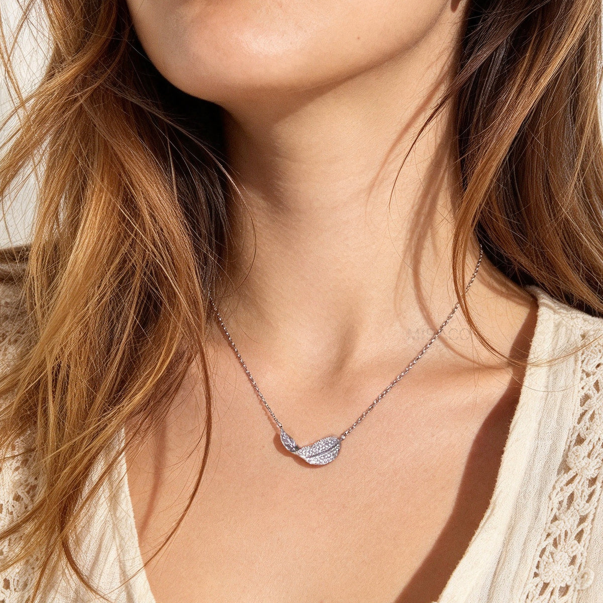 silver pavé crystal feather leaf pendant necklace and matching coil back clip-on earrings for unpierced ears.