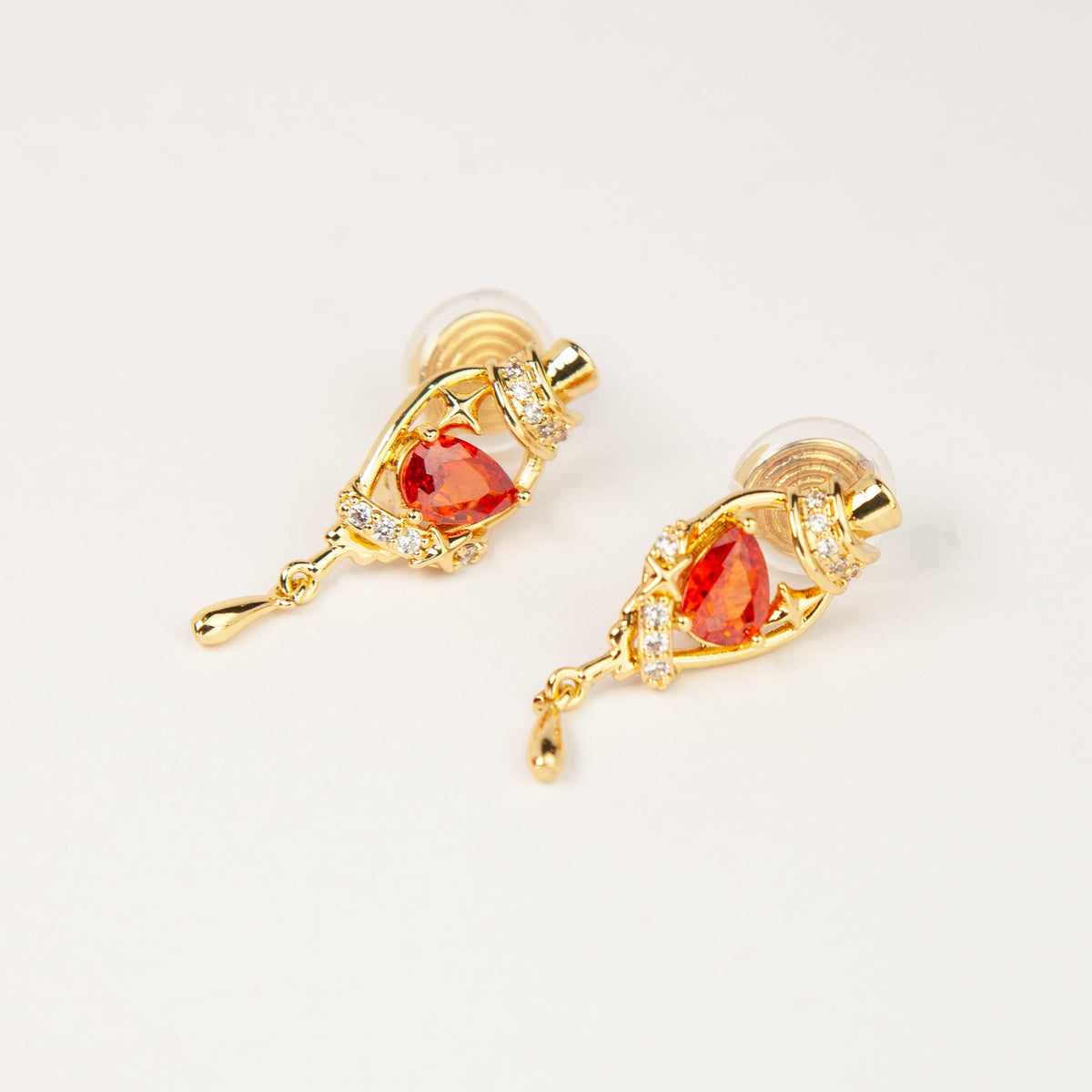 18K gold-plated royal crimson hat starburst teardrop clip-on earrings with red CZ stone and coil back non-pierced closure
