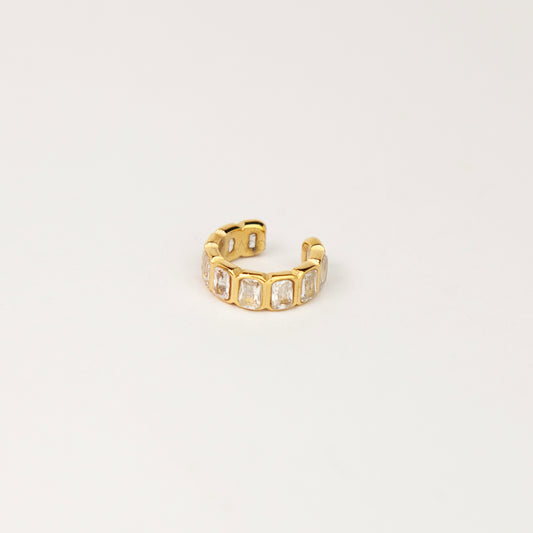 18K gold-plated stainless steel non-pierced ear cuff set with emerald-cut baguette cubic zirconia on her outer ear cartilage.