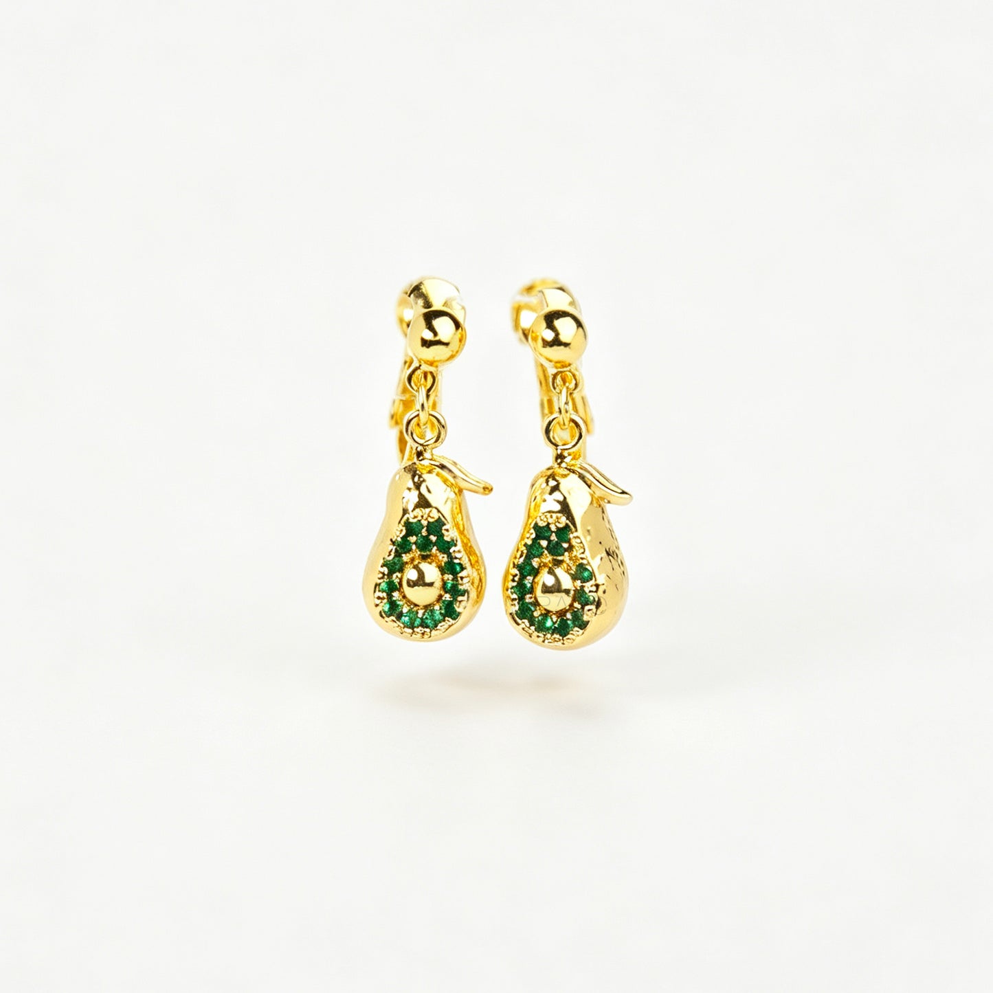 Pair of gold-toned non-pierced avocado clip-on drop earrings with green crystal accents and adjustable screw-back mechanisms.