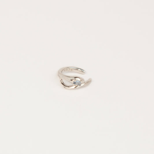 S925 sterling silver organic wave ear cuff clip-on featuring a small pale blue crystal stone worn on the conch of an unpierced ear.