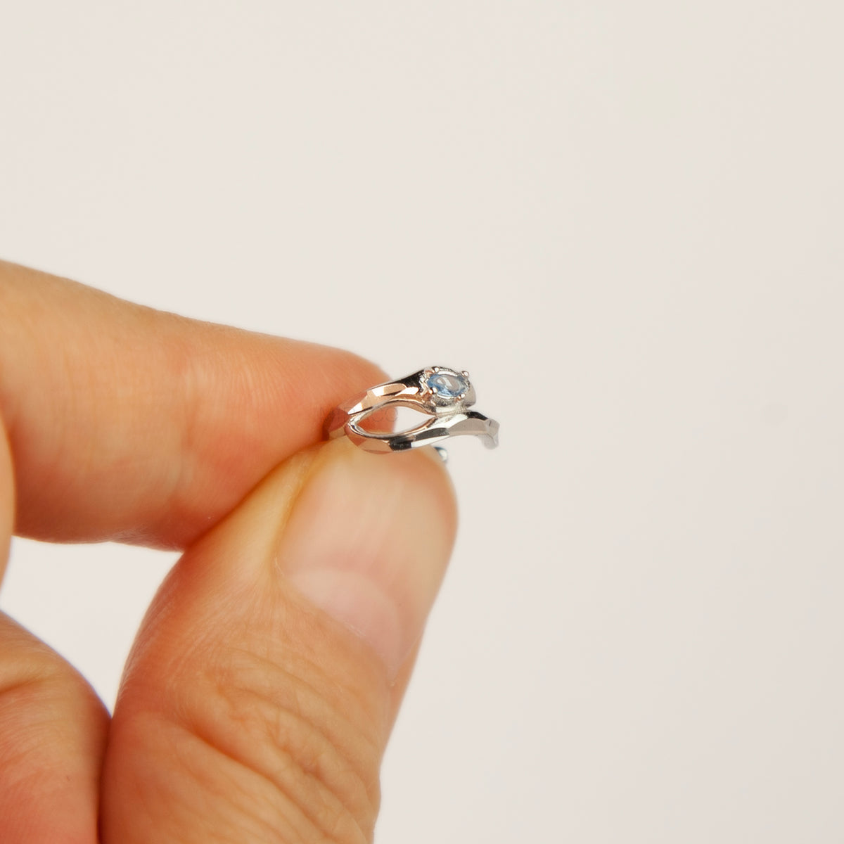 S925 sterling silver organic wave ear cuff clip-on featuring a small pale blue crystal stone worn on the conch of an unpierced ear.