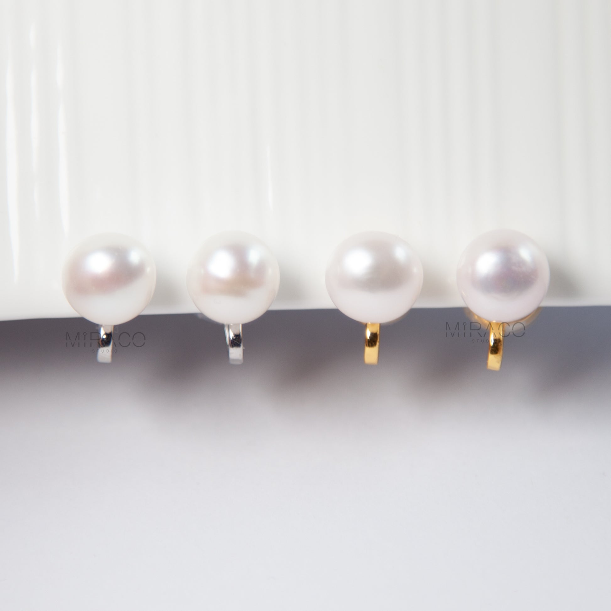 imeless Elegance with All-Day Comfort – No Piercing Needed.

These classic clip-on pearl stud earrings feature a single, lustrous white freshwater pearl (approx. 10–11mm), set on a minimalist silver or gold-tone flat coil clip. Understated and effortlessly chic, they're perfect for both everyday style and special occasions.

Designed for comfort, the flat coil back offers a secure hold while remaining gentle on non-pierced ears.