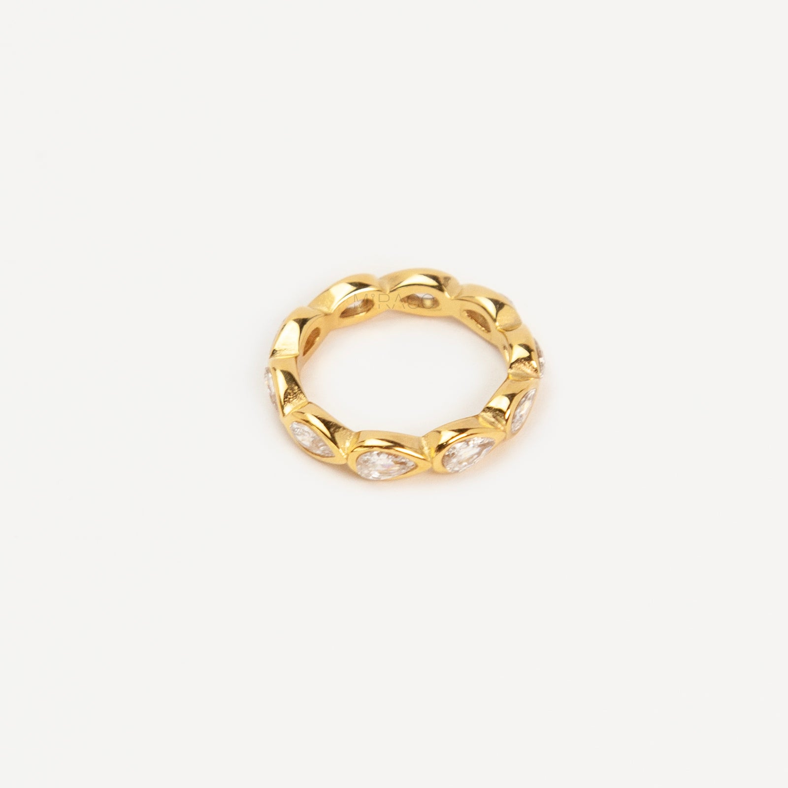 A high-shine gold-toned eternity ring made of stainless steel, featuring a continuous circle of bezel-set pear-cut clear crystals
